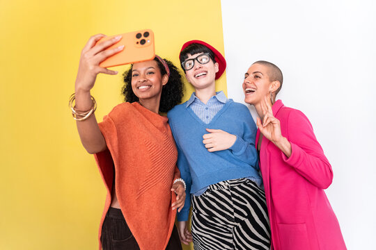 Three women taking a joyful business selfie together