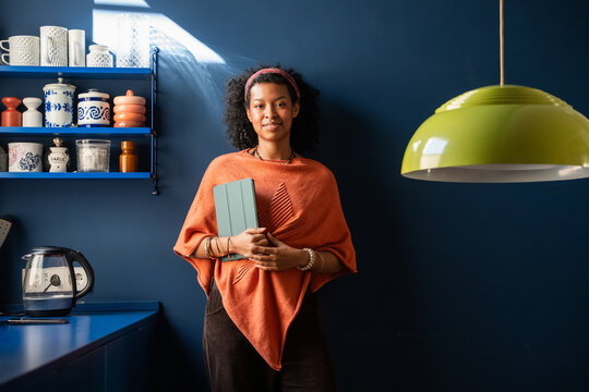 Creative woman in business setting holding a tablet
