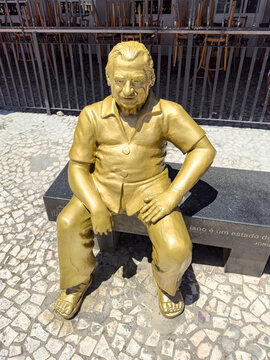 The statue of writer Jorge Amado, by Gervelson Chaves, depicts the writer sitting at a table in the Bar Ves&uacute;vio in the historic district, the setting for many of his novels. Ilh&eacute;us, Bahia, Brazil 2024