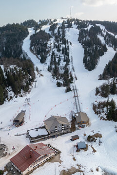 Winter ski resort in the Jura with forested slopes