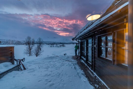 Snowy mountain dusk by cabin near Tromso, Norway