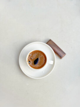 Minimal coffee break with espresso and chocolate on table