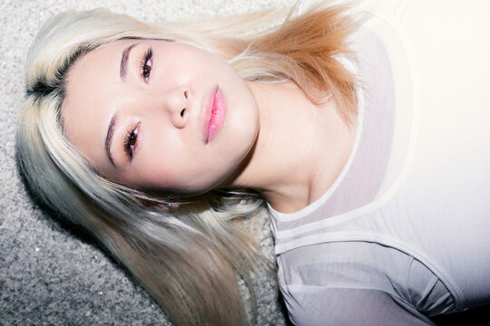 Flash portrait of Gen Z girl with platinum hair closeup