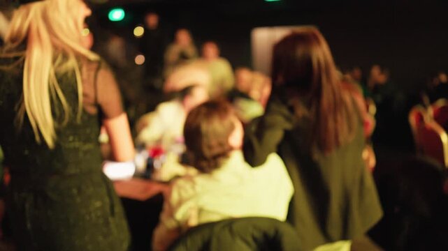 Vivid depiction of server engaging with guests amidst bustling restaurant surroundings
