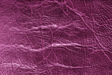 Fototapeta premium Detailed close up, macro of pink glossy metallic effect leather surface with visible wrinkles, creases and natural grain. Textured luxury material background, upholstery and design backdrop.