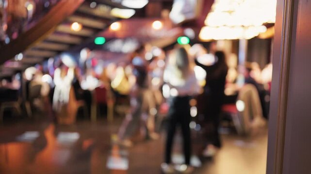 An active corridor view capturing hurried staff and blurred figures during event setup