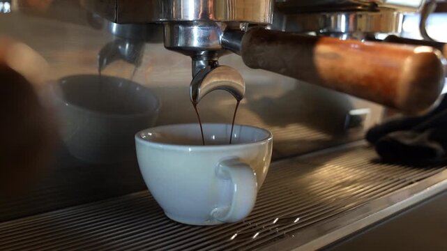 Fresh Espresso Pouring from Portafilter into Cup Close Up with Crema