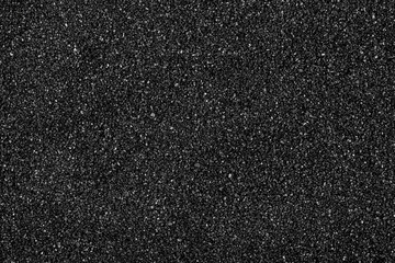 Fototapeta premium Black sand beach texture as background, top view. Volcanic sand background.