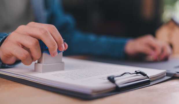 A corporate lawyer uses a legal stamp to approve contract authorization, ensuring document verification, compliance approval, business agreement validation, corporate governance, regulatory process