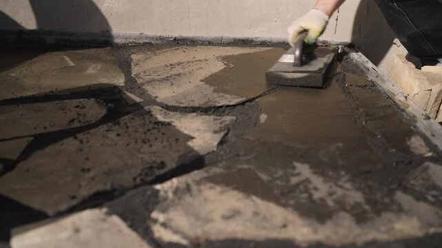 Worker Grouting Crazy Paving with Trowel