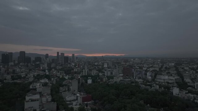Aerial drone flying forward over Parque M&eacute;xico in Colonia Condesa at sunrise with dramatic cloudy sky in M&eacute;xico City. Shot in D-Log M