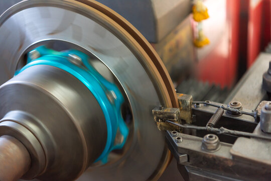 Automotive brake disc machining on lathe machine in workshop precision metal cutting process for vehicle maintenance and repair industrial engineering close up