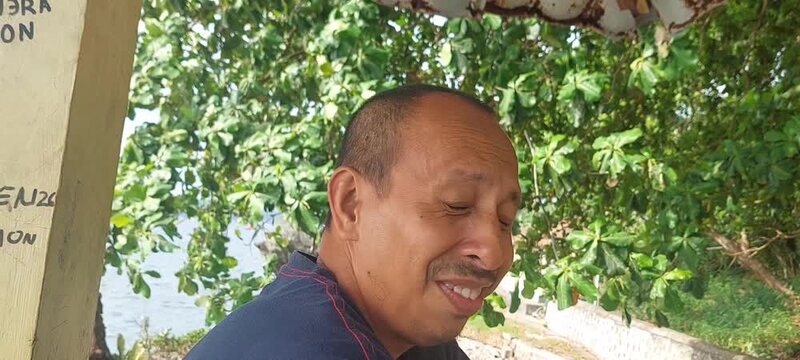 a handsome man is laughing with a funny expression looks funny