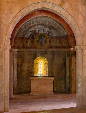 Le Thoronet Abbey interior chapel, Provence-Alpes-C&ocirc;te d&rsquo;Azur, France, 6 April 2026: Romanesque apse with altar and illuminated window