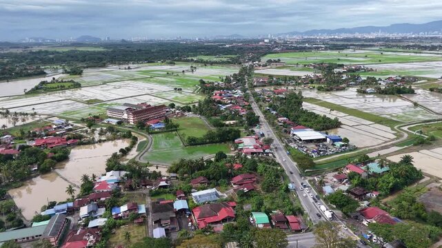 Aerial Labuh Banting green rice fields and village landscape
