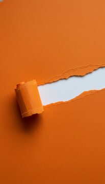 Orange textured paper tearing across the center, pulling back a curled edge and revealing a clean, bright white space underneath, creating a dynamic visual for new content or messages