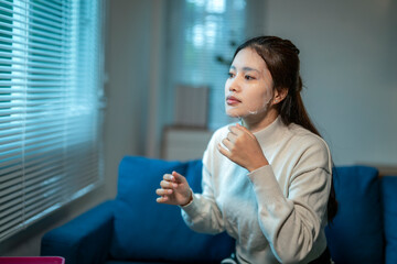 Young asian woman applying cosmetic face mask at home © Wasana