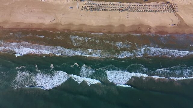 High Altitude Top Down Aerial Drone View of the Coastline at Miramar Beach During a Beautiful Sunrise Featuring Crashing Waves and Row of Palapas in Tampico Tamaulipas Mexico
