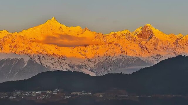 Cinematic timelapse showcasing the ethereal color shift from deep blue dawn to fiery gold on the peaks of Meili Snow Mountain.