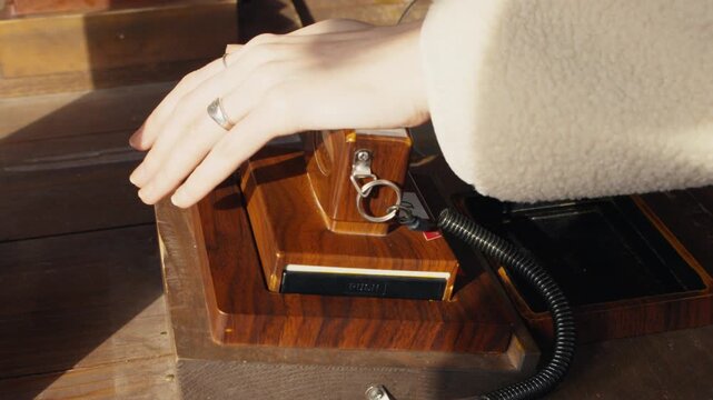 Woman stamping passport at a vintage wooden checkpoint