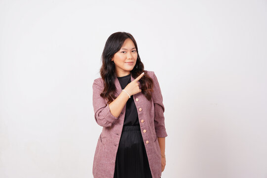 Smirking Professional Woman Pointing Finger to Side Direction
