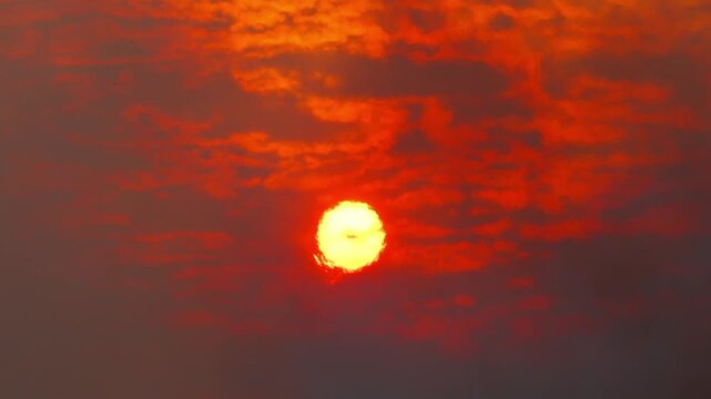 Red sun setting through a polluted sky from wildfire smoke