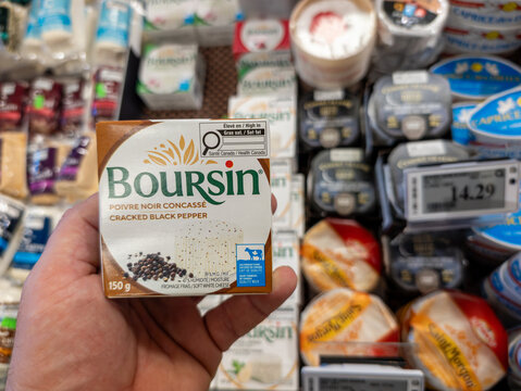 Canada, 22 February 2026 : Cheese Selection Aisle, Hand Holding Boursin, Cracked Black Pepper, Grocery Display