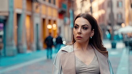 Fototapeta premium Motionless woman amid busy urban square scene concept. A woman walking through the city streets, showcasing urban life.