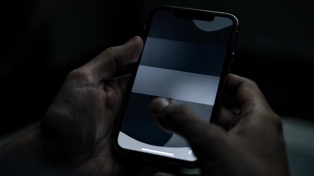 Mobile banking app interface zoomed in on transfer confirmation in dark mode on a phone main screen details clear with outoffocus hands holding the device.