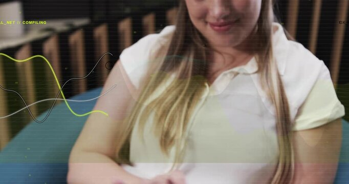 Woman tapping tablet on lap, starting COMPILING waveform for tech preview while camera pulling back