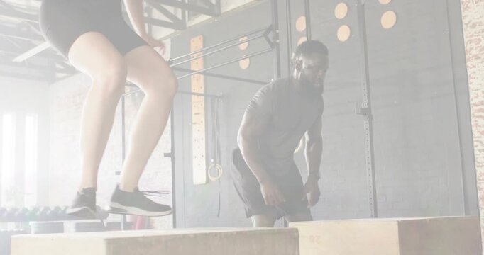Training partners starting from crouch and doing explosive box jumps for fitness, with color lines