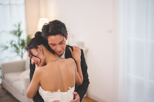 Romantic wedding couple embracing and dancing with love at home