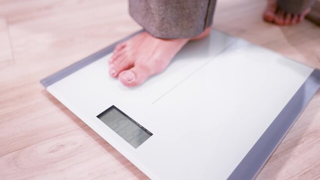 Bare Feet Standing on Digital Bathroom Scale for Weight Measurement
