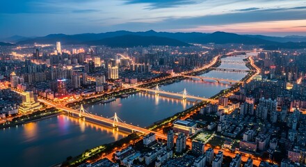 Fototapeta premium Aerial View of Illuminated Cityscape at Dusk with Bridges and River