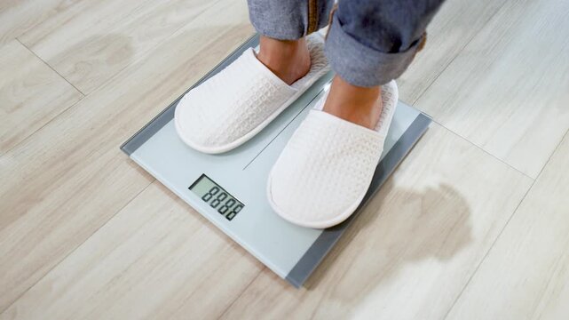 Person in White Slippers Stepping on Digital Bathroom Scale to Check Weight