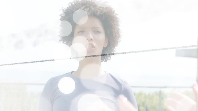 Woman on deck squinting from sun, responding to peer gesturing while bokeh hiding face in business