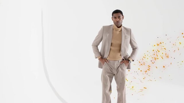 Male model fixing lapels glancing left touching stroke leaning showing fashion with edge confetti