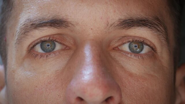 Serious male eyes stare directly at camera showing determination and focus. Intense human gaze represents discipline responsibility and mental strength used for leadership motivation, mindset concepts