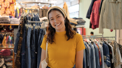 Young teen Gen Z asia female happy smile looking at camera at zero waste eco go green buy second...