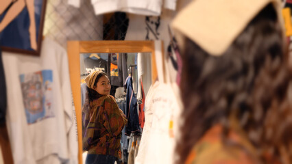 Young tourist Gen Z asia female choose look at zero waste eco go green buy second hand sale store...