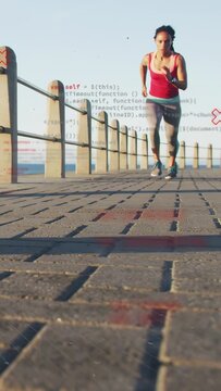 Vertical video: Woman nearing cam, speeding for training on seaside, code overlay appearing benign