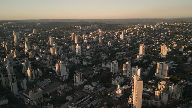Drone footage of  buildings at sunset in downtown Chapec&oacute;.