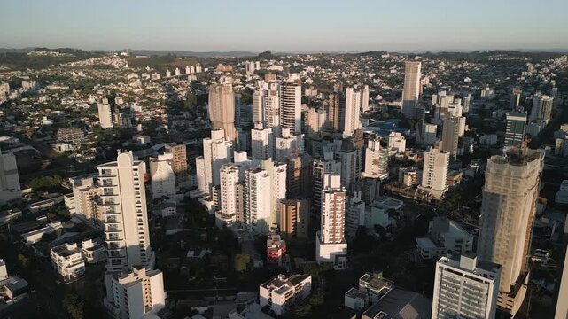 Drone footage of  buildings at sunset in downtown Chapec&oacute;.