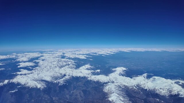 Elevated spinning view of the snow-capped Alps taken from a jet cokpit. Hyperlapse.