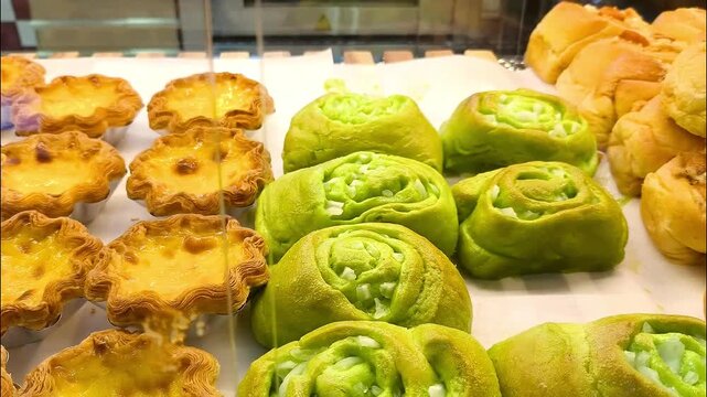 A bakery display case filled with various types of bread  
