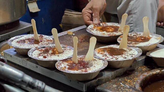 Indian tasty street food dahi vada. It is prepared by soaking vadas in thick dahi