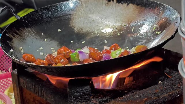 Street food vendor preparing delicious veg manchurian. Popular indo chinese street food