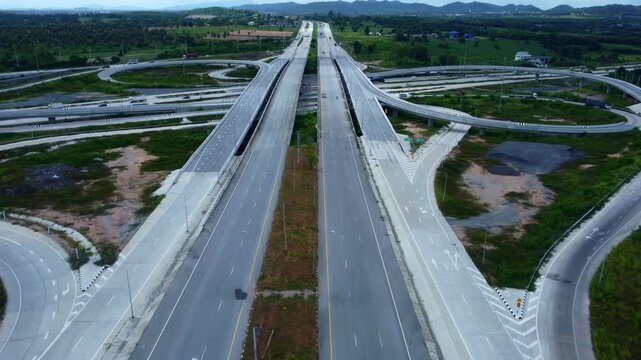 Complex highway interchange with traffic movement viewed from above represents urban mobility, advanced construction systems, and the integration of modern transport infrastructure and smart logistics