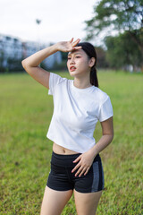 Woman shielding face from sun after outdoor workout
