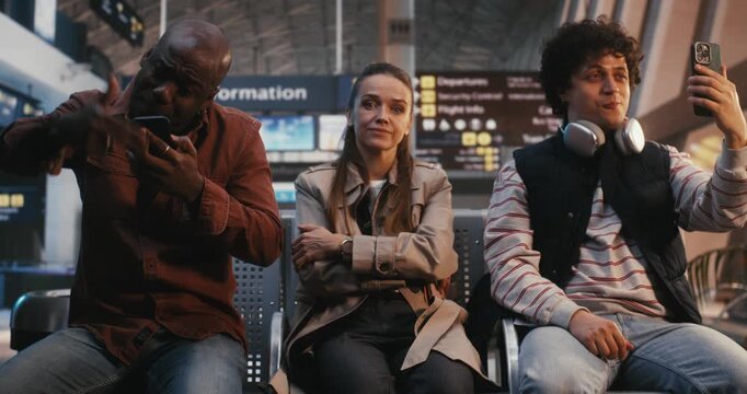 Female Traveler Sits in Airport Area, Displaying Stoic Endurance Despite Clear Discomfort of Crowded Setting. Resilience of Sensitive Individuals Navigating Modern Life Logistical and Social Chaos.